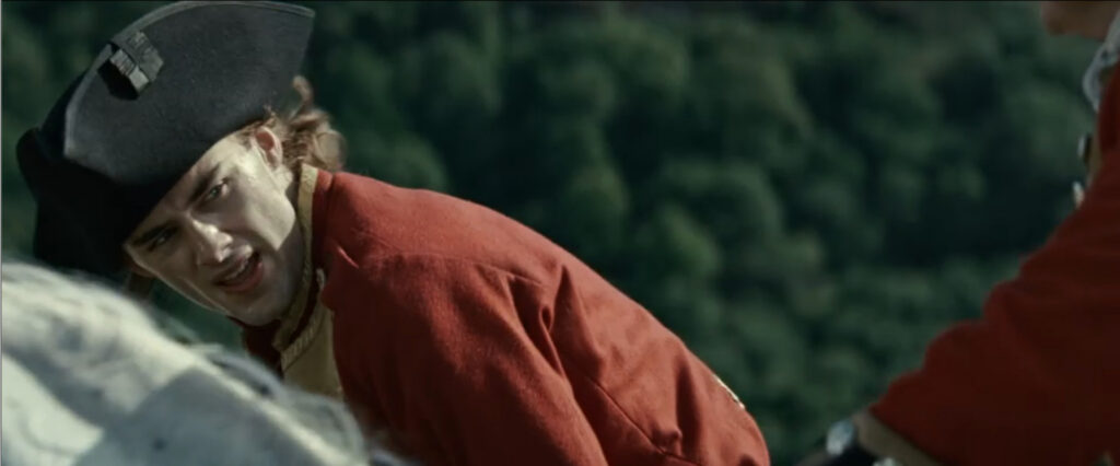 Close-up of a young soldier in a red coat and black tricorn hat in Young Washington.